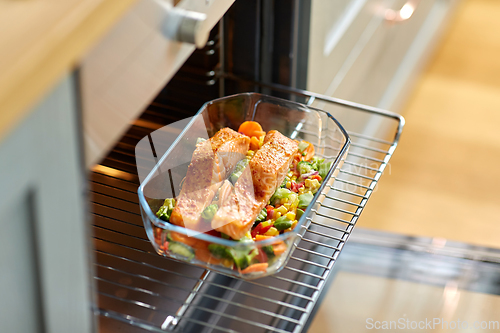 Image of food cooking in baking dish in oven at home