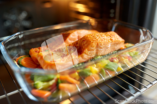 Image of food cooking in baking dish in oven at home