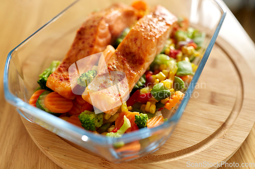 Image of salmon fish in baking dish on kitchen table