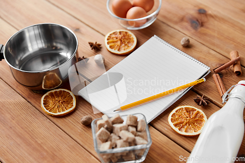 Image of notebook, pencil, ingredients for eggnog cooking