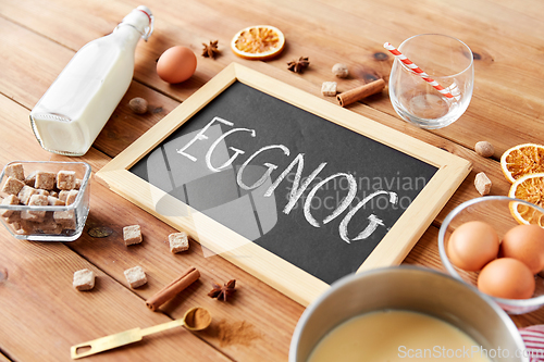 Image of eggnog word on chalkboard, ingredients and spices