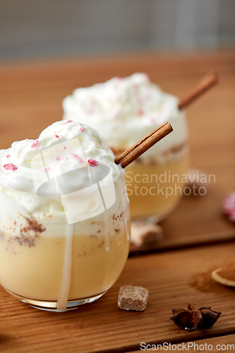 Image of glasses of eggnog with whipped cream and cinnamon