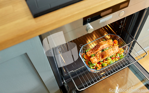 Image of food cooking in baking dish in oven at home