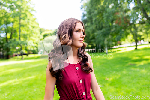 Image of portrait of beautiful woman at summer park