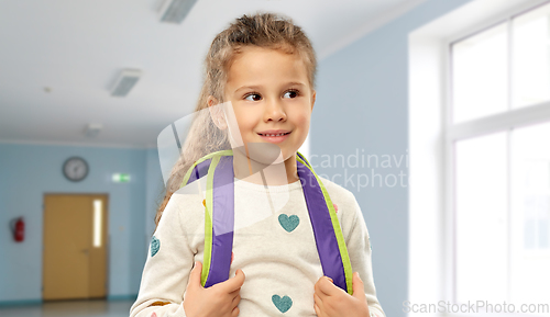 Image of happy little girl with backpack at school