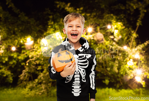 Image of happy boy in halloween costume with jack-o-lantern