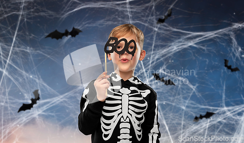 Image of boy in halloween costume of skeleton making faces