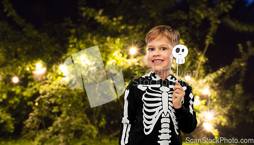 Image of boy in halloween costume of skeleton making faces