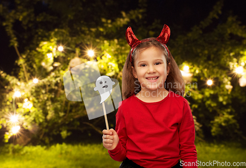 Image of girl in halloween costume with ghost party prop