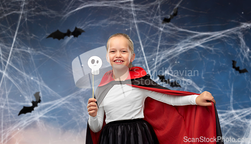 Image of girl in costume of dracula with cape on halloween