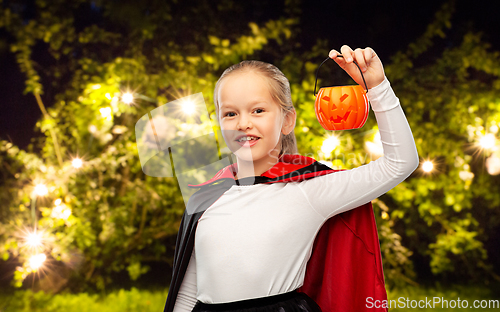 Image of girl in halloween costume of dracula with pumpkin