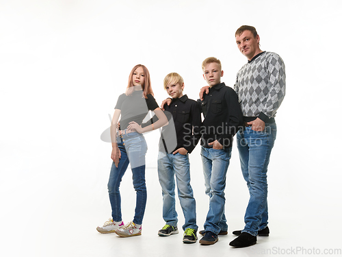 Image of Dad, two sons and daughter in casual clothes in dark colors, full length portrait, white background