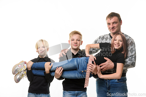 Image of Dad and two sons holding a teenage girl in their arms, casual wear in dark colors, white background
