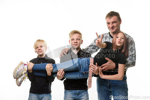 Image of Dad and two sons hold a teenage girl in their arms, girl casual clothes in dark colors, white background