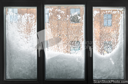 Image of window glass covered with snow in winter