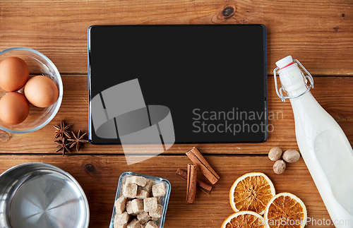 Image of tablet pc, ingredients for eggnog cooking