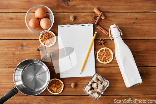 Image of notebook, pencil, ingredients for eggnog cooking