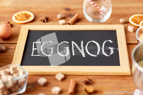 Image of eggnog word on chalkboard, ingredients and spices