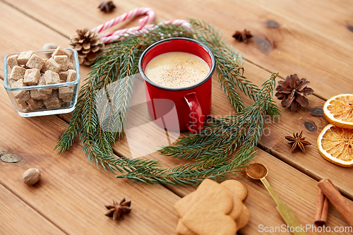 Image of cup of eggnog, fir branches, gingerbread and sugar