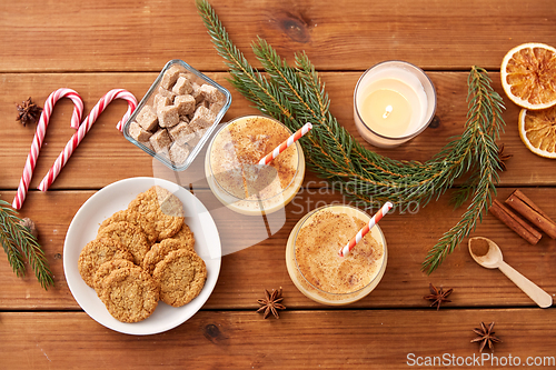 Image of glasses of eggnog, oatmeal cookies and fir branch