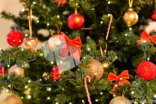 Image of decorated artificial christmas tree at home