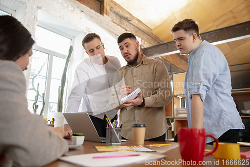 Image of Front view colleagues working together in a office using modern devices and gadgets during creative meeting