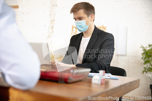 Image of Man, manager working in a office using modern devices and gadgets during creative meeting