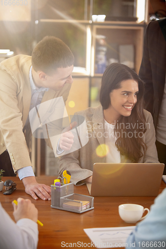 Image of Front view colleagues working together in a office using modern devices and gadgets during creative meeting