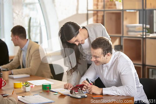 Image of Side view colleagues working together in a office using modern devices and gadgets during creative meeting