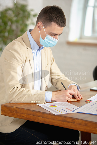 Image of Man, manager working in a office using modern devices and gadgets during creative meeting