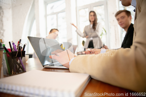 Image of Side view colleagues working together in a office using modern devices and gadgets during creative meeting