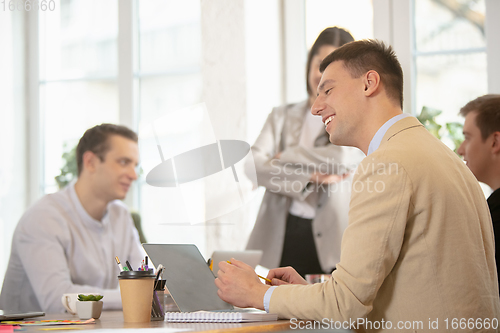 Image of Side view colleagues working together in a office using modern devices and gadgets during creative meeting