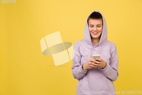 Image of Caucasian girl\'s portrait isolated on yellow studio background with copyspace