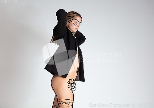 Image of Young blonde beautiful naked woman with line art drawing illustration on body