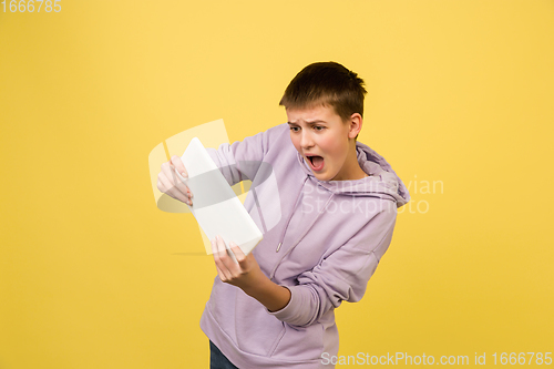 Image of Caucasian girl\'s portrait isolated on yellow studio background with copyspace