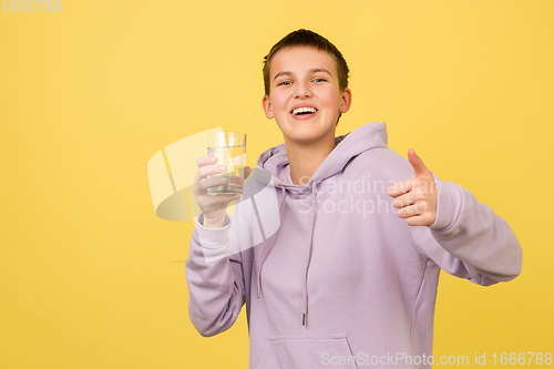 Image of Caucasian girl\'s portrait isolated on yellow studio background with copyspace