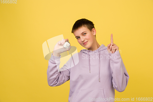 Image of Caucasian girl\'s portrait isolated on yellow studio background with copyspace