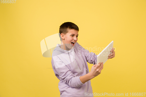 Image of Caucasian girl\'s portrait isolated on yellow studio background with copyspace