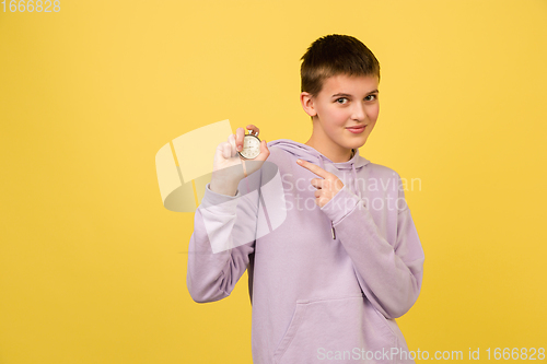 Image of Caucasian girl\'s portrait isolated on yellow studio background with copyspace