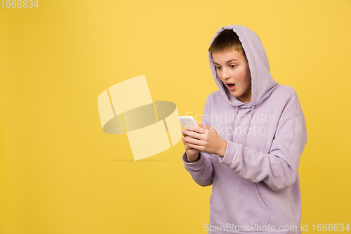 Image of Caucasian girl\'s portrait isolated on yellow studio background with copyspace