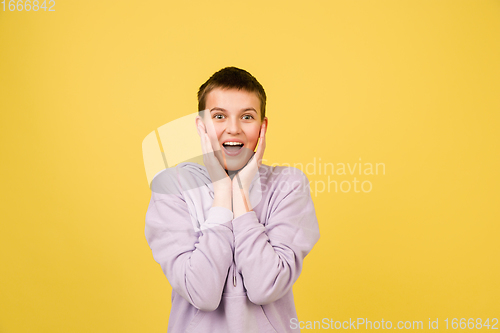 Image of Caucasian girl\'s portrait isolated on yellow studio background with copyspace