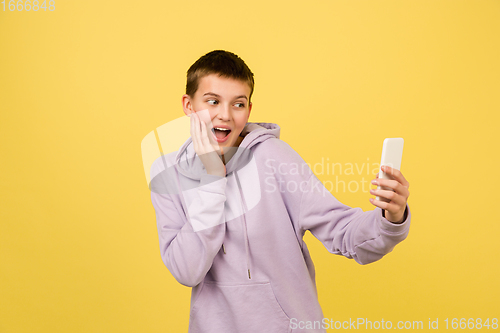 Image of Caucasian girl\'s portrait isolated on yellow studio background with copyspace