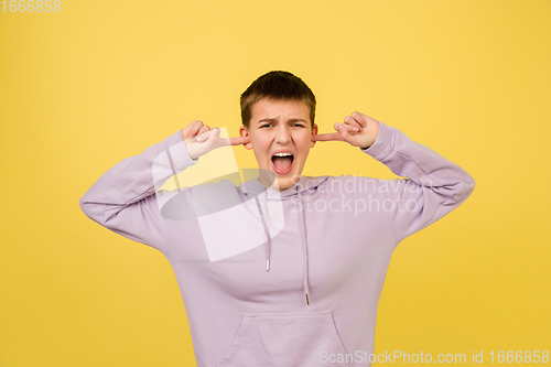 Image of Caucasian girl\'s portrait isolated on yellow studio background with copyspace