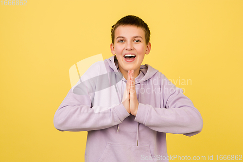 Image of Caucasian girl\'s portrait isolated on yellow studio background with copyspace