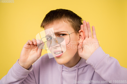 Image of Caucasian girl\'s portrait isolated on yellow studio background with copyspace