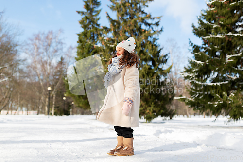 Image of happy little girl in winter clothes outdoors