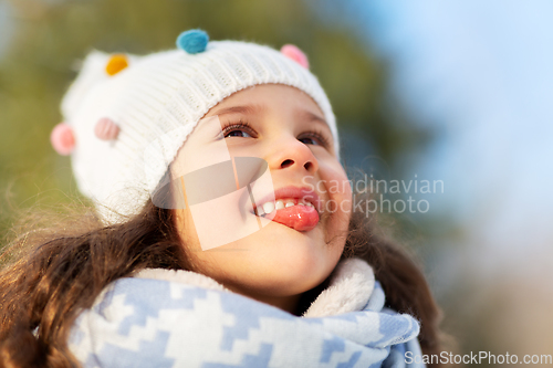 Image of happy little girl having fun at winter park