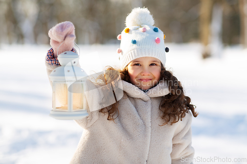 Image of happy little girl with christmas lantern in winter