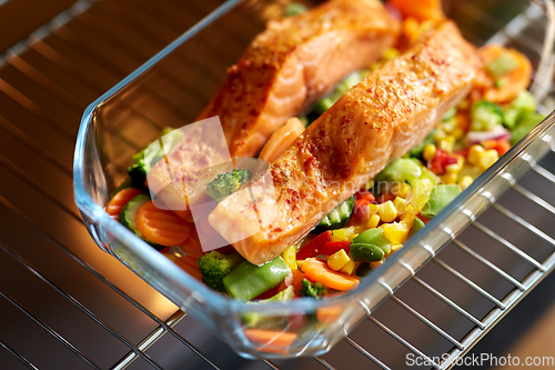 Image of food cooking in baking dish in oven at home