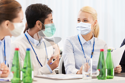 Image of business people in masks at meeting or conference